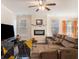 Relaxing living room with sectional sofa, fireplace, and large windows at 188 Sophie Cir, Locust Grove, GA 30248