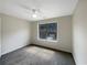 Well-lit bedroom with carpet and a large window overlooking the neighborhood at 6566 Splitpine Ct, Atlanta, GA 30349