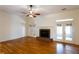 Spacious living room with hardwood floors, fireplace, and French doors at 1210 Lancelot Ct, Loganville, GA 30052