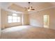 Spacious main bedroom with carpeted floors and a ceiling fan at 1210 Lancelot Ct, Loganville, GA 30052