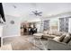 Open concept living room with a view into the kitchen and a large sectional sofa at 421 Bedford Xing, Mcdonough, GA 30253