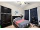 Bedroom with a striped bedspread, dresser, and gaming chair at 421 Bedford Xing, Mcdonough, GA 30253