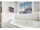 Relaxing bathroom with a garden tub and tile surround at 421 Bedford Xing, Mcdonough, GA 30253