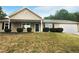 Tan house exterior with black door and garage at 55 Dayton Way, Covington, GA 30016