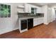 Modern kitchen with white cabinets, granite countertops, and stainless steel appliances at 55 Dayton Way, Covington, GA 30016