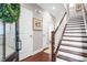 Bright and spacious entryway with hardwood floors and staircase at 537 Mirrormont Se Dr, Smyrna, GA 30080