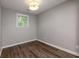 Simple bedroom with hardwood floors and a window at 2911 Glenwood Se Ave, Atlanta, GA 30317
