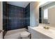 Bathroom with dark tile, shower/tub combo, and vanity at 2911 Glenwood Se Ave, Atlanta, GA 30317