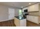 Updated kitchen featuring white cabinets and granite countertops at 2911 Glenwood Se Ave, Atlanta, GA 30317