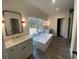 Modern bathroom featuring a soaking tub, double vanity, and separate shower at 262 Green Hill Rd, Sandy Springs, GA 30342