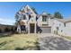 Front exterior of a modern two-story home with a gray brick facade, wood accents, and a two-car garage at 262 Green Hill Rd, Sandy Springs, GA 30342