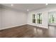 Spacious living room with hardwood floors and large windows overlooking a balcony at 1129 Rivard Nw Cir, Atlanta, GA 30318