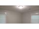 Simple bedroom with neutral walls, vinyl flooring, and two windows at 973 Neal Nw St, Atlanta, GA 30314