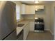Kitchen with white cabinets, granite countertops, and stainless steel appliances at 973 Neal Nw St, Atlanta, GA 30314