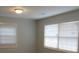 Simple bedroom with neutral walls, vinyl flooring and two windows at 973 Neal Nw St, Atlanta, GA 30314