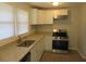 Kitchen with white cabinets, granite countertops, and stainless steel appliances at 973 Neal Nw St, Atlanta, GA 30314
