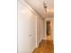 Hallway with two large closets and wood flooring leading to bathroom at 130 26Th Nw St # 211, Atlanta, GA 30309