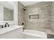 Modern bathroom with gray tiled walls, white vanity, bathtub, and a lighted mirror at 2910 3Rd Sw Ave, Atlanta, GA 30315