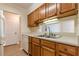 Bright kitchen with wood cabinets, tile floors, and stainless steel sink at 300 Johnson Ferry Ne Rd # B608, Atlanta, GA 30328