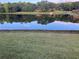 Serene lake reflecting the sky, surrounded by lush greenery and trees at 1078 Highway 92 S, Fayetteville, GA 30215