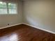 Bright bedroom featuring hardwood floors and a view at 1078 Highway 92 S, Fayetteville, GA 30215