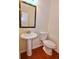 Small bathroom with pedestal sink, toilet and mirror at 1957 Brightleaf Way # 59, Marietta, GA 30060