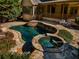 Freeform pool and hot tub with flagstone patio at 311 Bradford Falls Trce, Canton, GA 30114