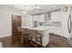 Modern kitchen with white cabinets, island with seating, and sliding barn door at 435 Webb Dr, Norcross, GA 30071