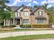 Brick two-story house with stone accents, double front doors, and manicured landscaping at 6625 Baywood Run, Cumming, GA 30041