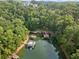 Aerial view of waterfront property with private docks and lush greenery at 6625 Baywood Run, Cumming, GA 30041