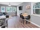 Open dining area with wood table and black chairs near kitchen at 2408 Hillcrest Dr, East Point, GA 30344