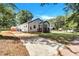 House features a long driveway and a spacious front yard at 2408 Hillcrest Dr, East Point, GA 30344