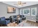 Open living area with hardwood floors, sectional sofa, and large windows at 2408 Hillcrest Dr, East Point, GA 30344