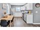 Eat-in kitchen with white cabinets, granite counters, and stainless steel appliances at 2408 Hillcrest Dr, East Point, GA 30344