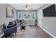 Bright living room with hardwood floors, sectional sofa, and large TV at 2408 Hillcrest Dr, East Point, GA 30344