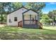 Newly renovated home with a charming front porch and well-maintained lawn at 2408 Hillcrest Dr, East Point, GA 30344