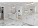 Double vanity bathroom with marble flooring and walk-in closet at 410 Ward Farm Dr, Powder Springs, GA 30127