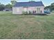 Backyard view of a single-story home with a wooden deck and grassy lawn at 1755 King Mill Rd, Mcdonough, GA 30252