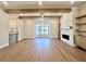 Bright living room showcasing hardwood floors, fireplace, and large windows at 265 Briscoe Way # 4, Alpharetta, GA 30009