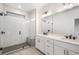 Modern bathroom with double vanity, walk-in shower, and white tile at 3074 Kelly St, Scottdale, GA 30079