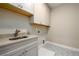 Laundry room with cabinets, sink, and patterned floor. Convenient and stylish at 2408 Meadow Church Rd, Duluth, GA 30097