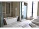 Luxurious bathroom with a modern bathtub, glass shower, and stone tile at 88 W Paces Ferry Nw Rd # 1130, Atlanta, GA 30305