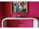 Modern console table with artwork and books in a pink room at 88 W Paces Ferry Nw Rd # 1130, Atlanta, GA 30305