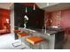 Stainless steel kitchen island with orange leather barstools at 88 W Paces Ferry Nw Rd # 1130, Atlanta, GA 30305