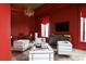 Red-walled office with a large desk, chandelier, and ample natural light at 88 W Paces Ferry Nw Rd # 1130, Atlanta, GA 30305