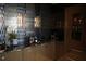 Stylish wet bar with dark cabinetry, glass-front storage, and granite countertop at 88 W Paces Ferry Nw Rd # 1130, Atlanta, GA 30305