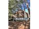 Rear view of a wood-sided home showcasing a deck and surrounding landscape at 1876 Madrona Nw St, Atlanta, GA 30318