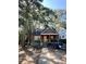 Ranch style home with wood siding and a covered porch, nestled among tall trees at 1876 Madrona Nw St, Atlanta, GA 30318