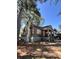 Side view of a charming ranch home with wood siding and a tree-lined setting at 1876 Madrona Nw St, Atlanta, GA 30318