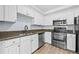 Modern kitchen with stainless steel appliances and granite countertops at 1850 Cotillion Dr # 2323, Atlanta, GA 30338